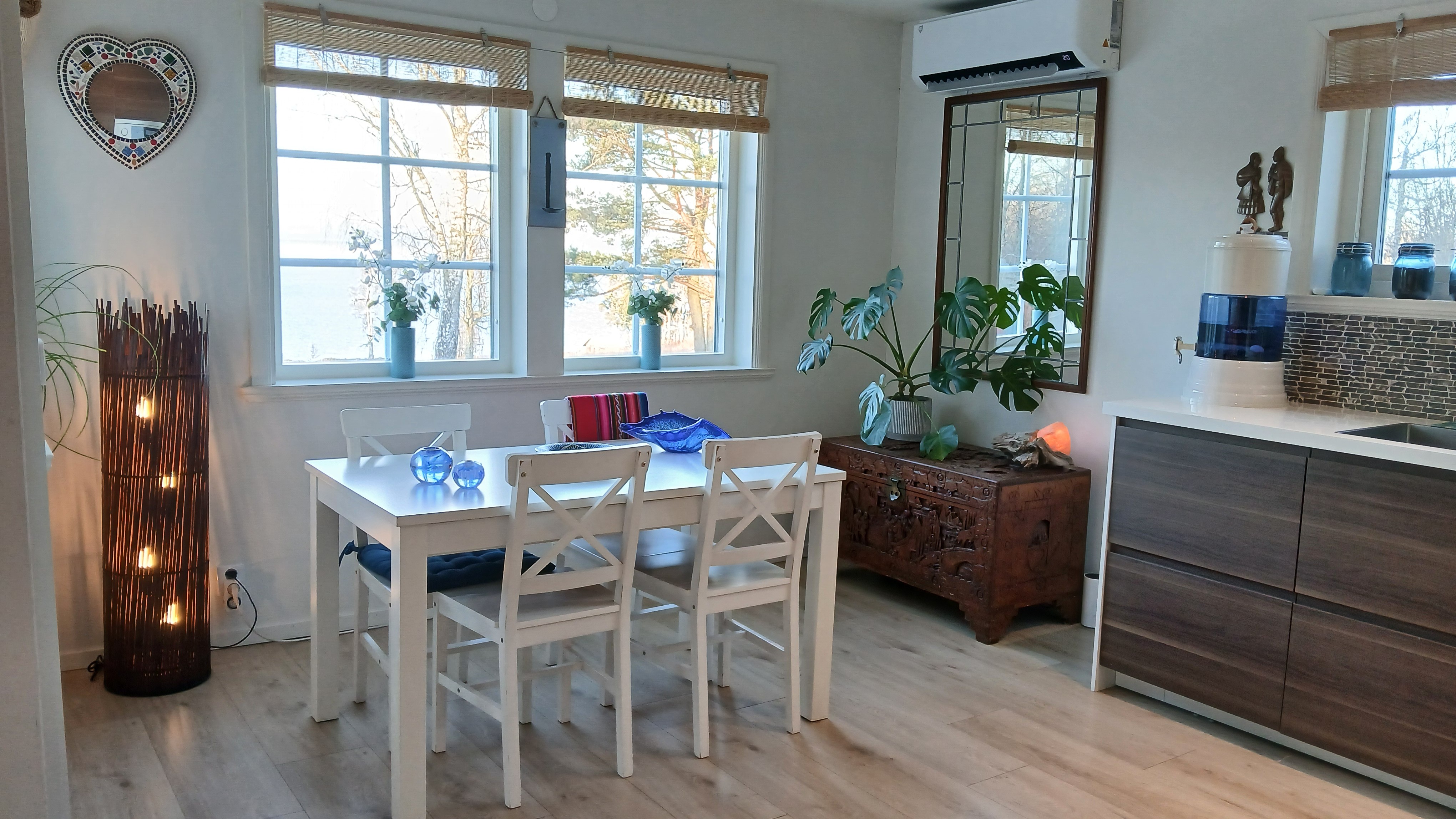 White dining table and chairs beside the Villa kitchen
