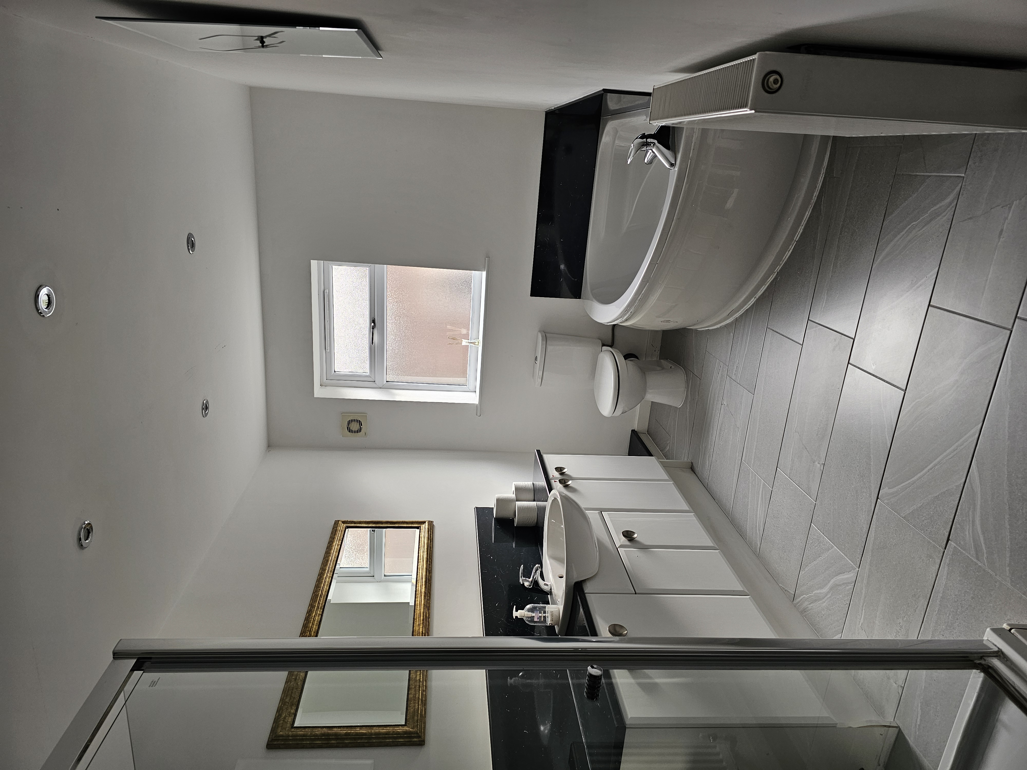 Main bedroom, comples with shower, bath, toilet and sink